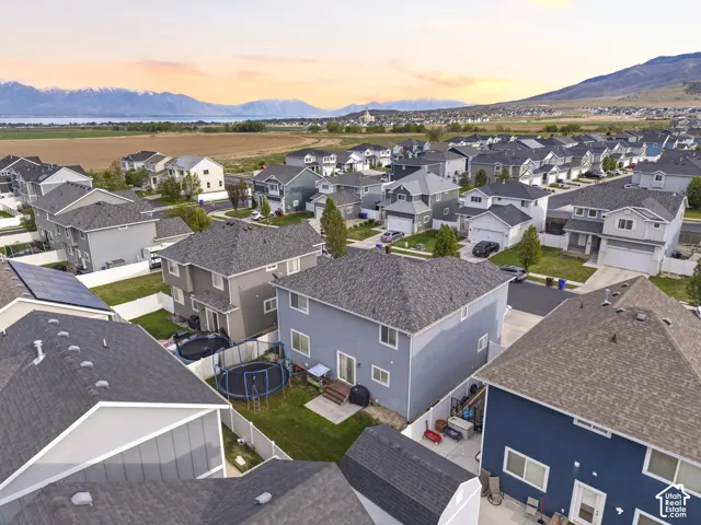Aerial community perspective showcasing multiple residential properties under a twilight sky