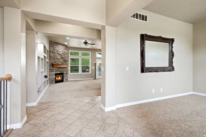 Tiled entry flooring transitioning to carpeting