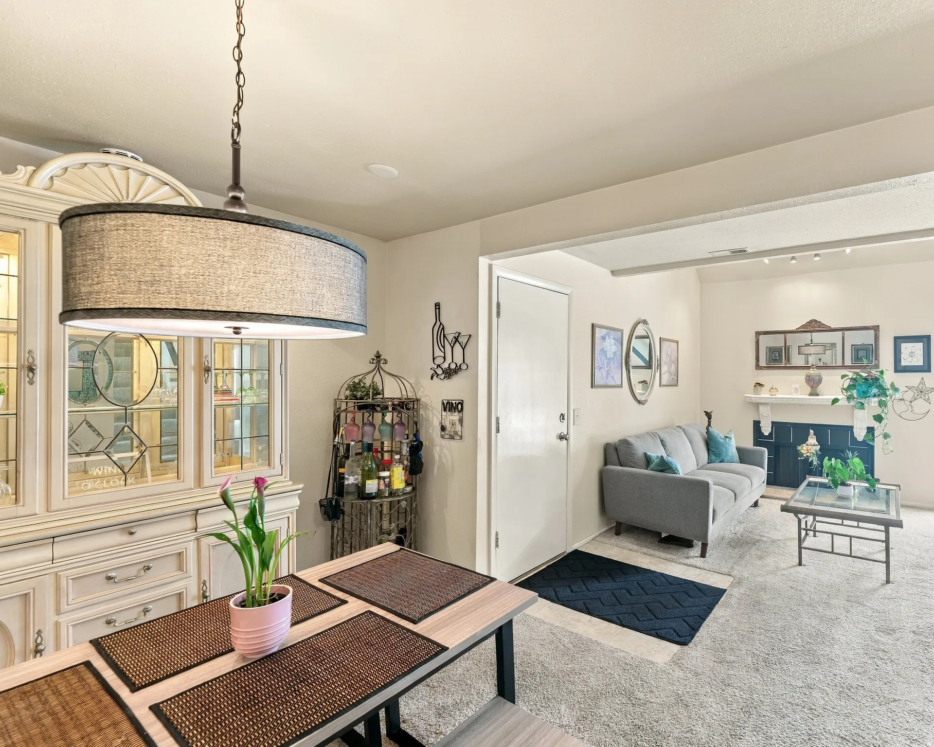 Recessed lighting, a built-in display cabinet with glass doors, and a decorative fireplace