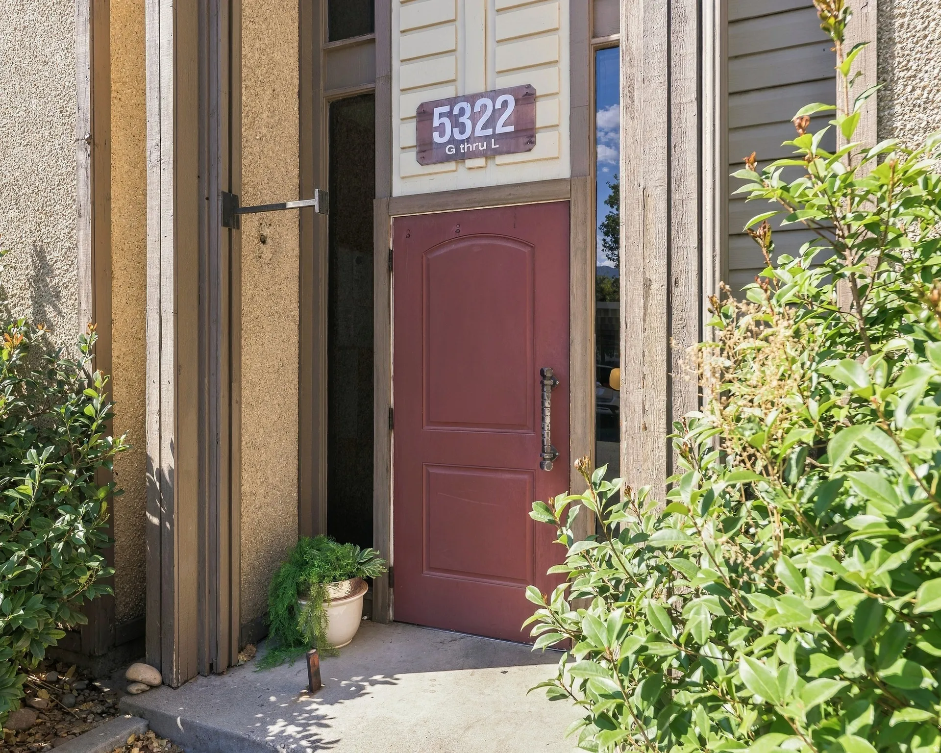 Red entry door with an ornamental handle