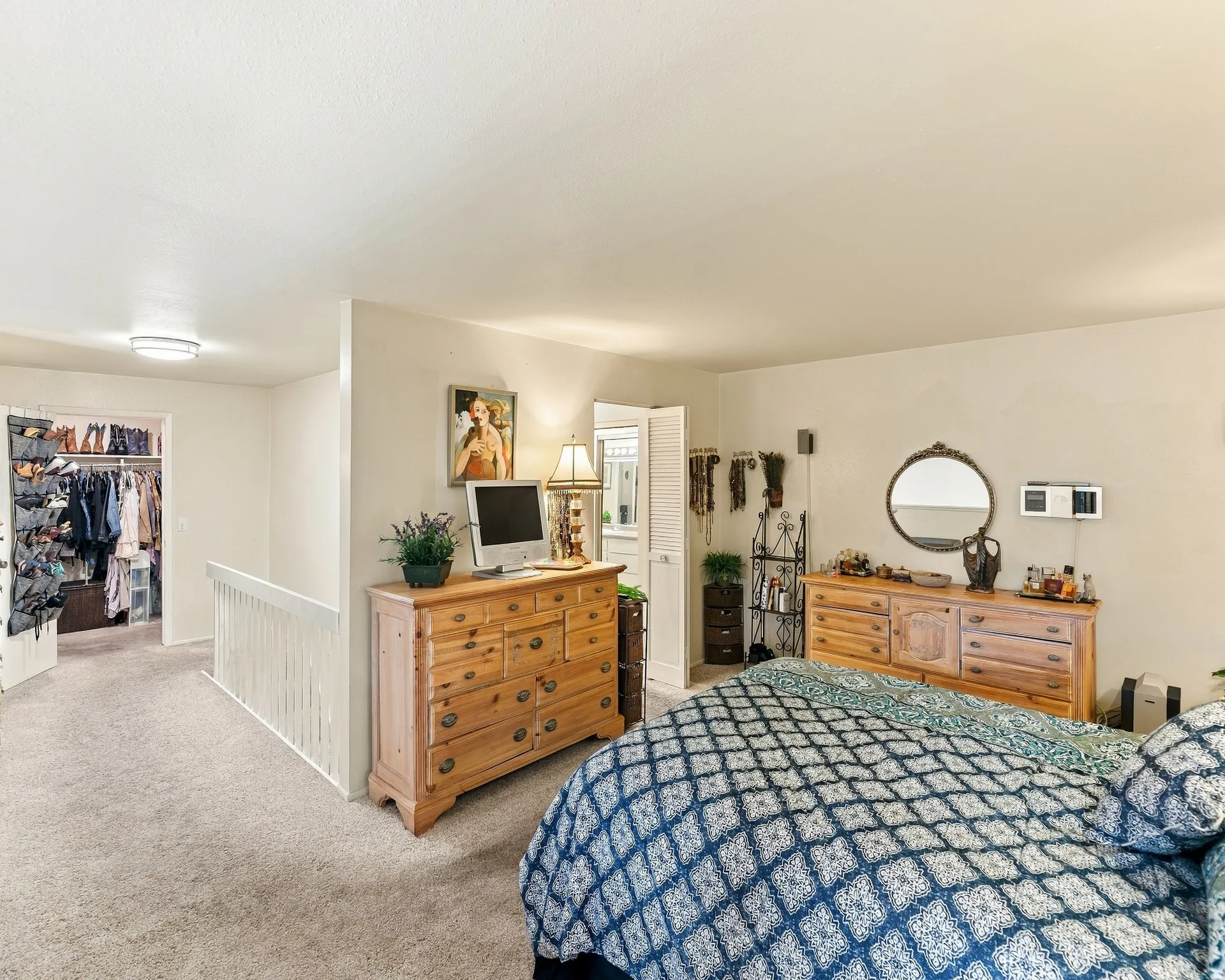 Carpeted flooring throughout, recessed ceiling lighting, and a white interior railing