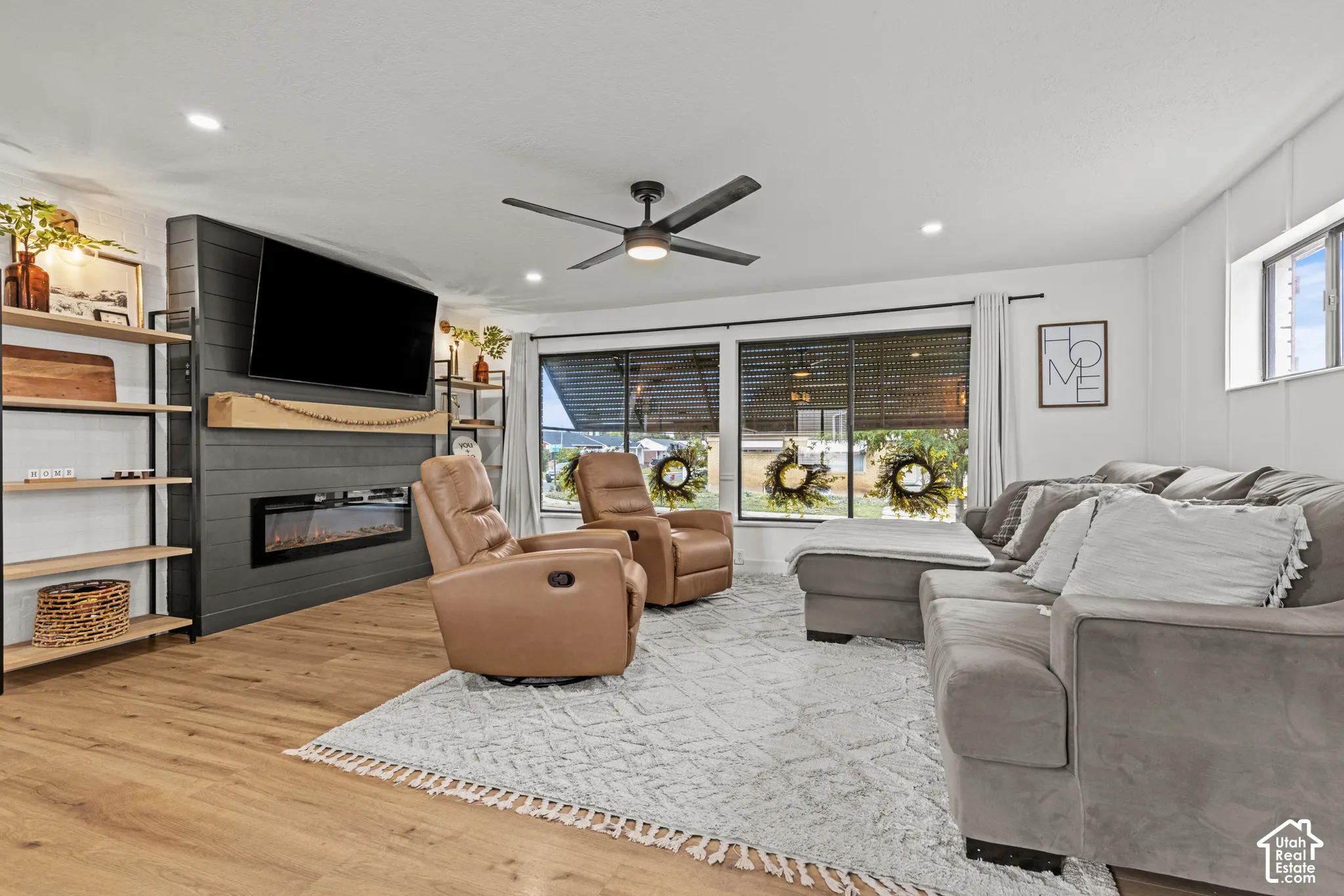 Wood-finish flooring, recessed lighting, and a ceiling fan with integrated lighting