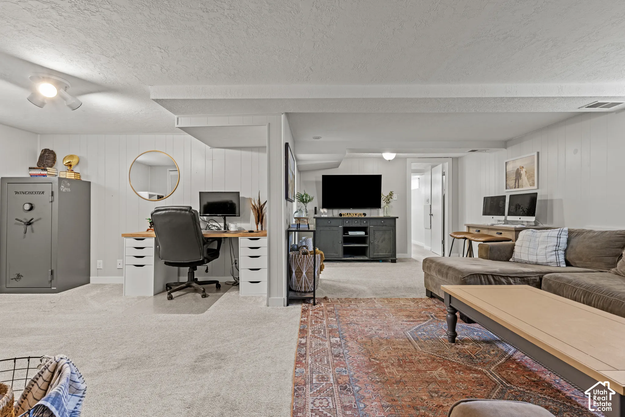 Carpeted flooring throughout, recessed lighting, and white paneled walls