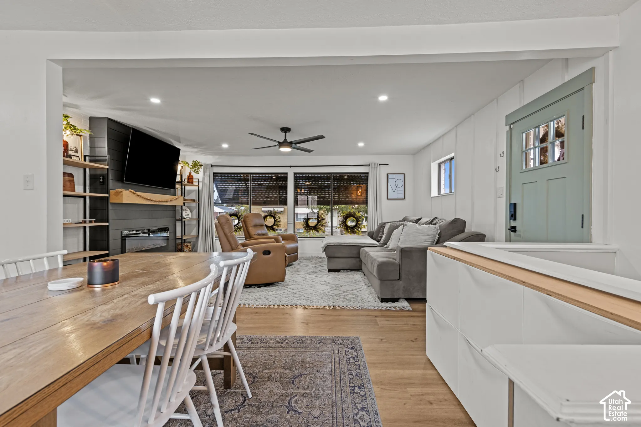 Recessed lighting, wood-finish flooring, ceiling fan, fireplace with mantel, and built-in shelving