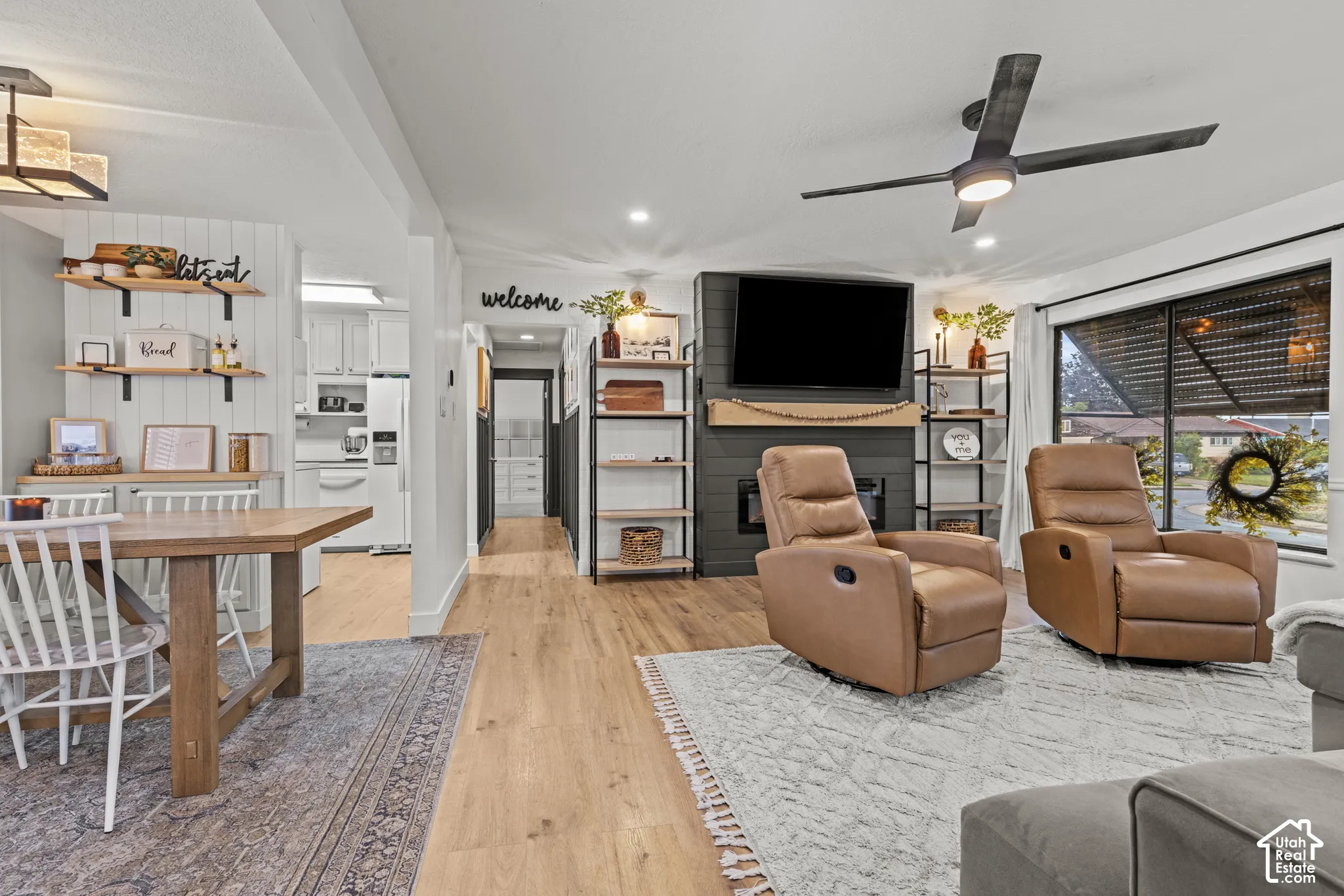 Wood-finish flooring throughout, recessed lighting, and a dark-toned ceiling fan