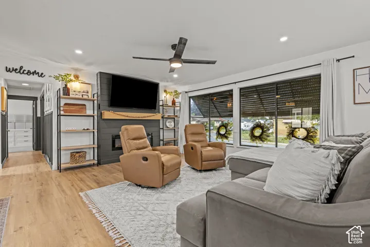 Spacious living area featuring wood-finish flooring, recessed lighting, and a ceiling fan
