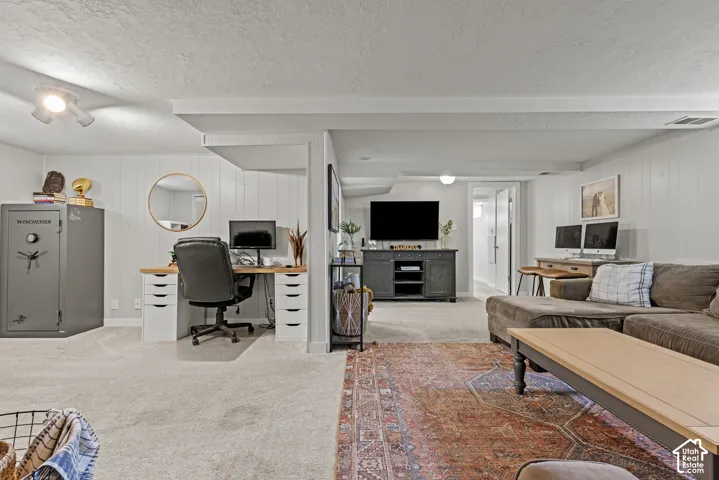 Carpeted flooring throughout, recessed lighting, and white paneled walls