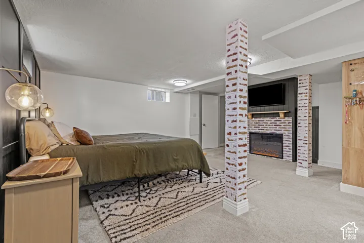 Built-in electric fireplace with brick surround, wood mantel, and shiplap accent wall