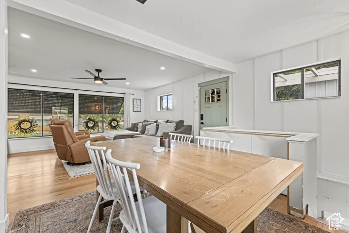 Open-concept living area featuring wood-finish flooring, recessed lighting, and a ceiling fan