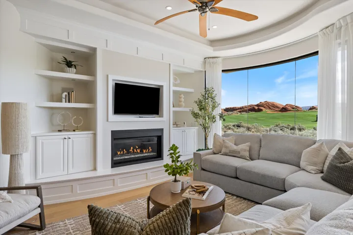 Living area featuring custom built-in cabinetry, an integrated fireplace, and wood-finish flooring