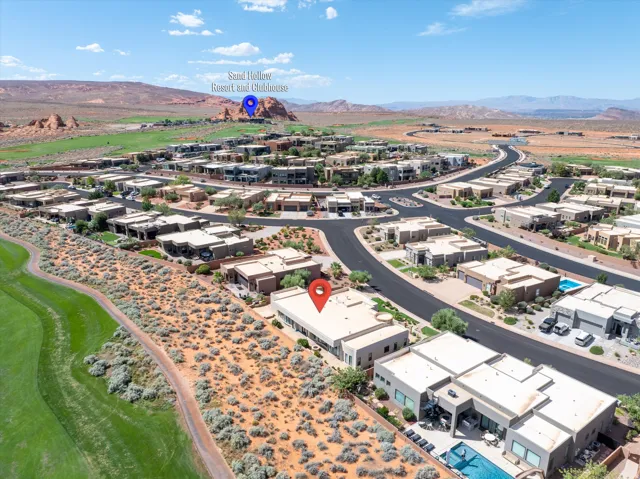 Contemporary residential architecture, golf course adjacency, desert landscaping, community roadways, and mountain scenery