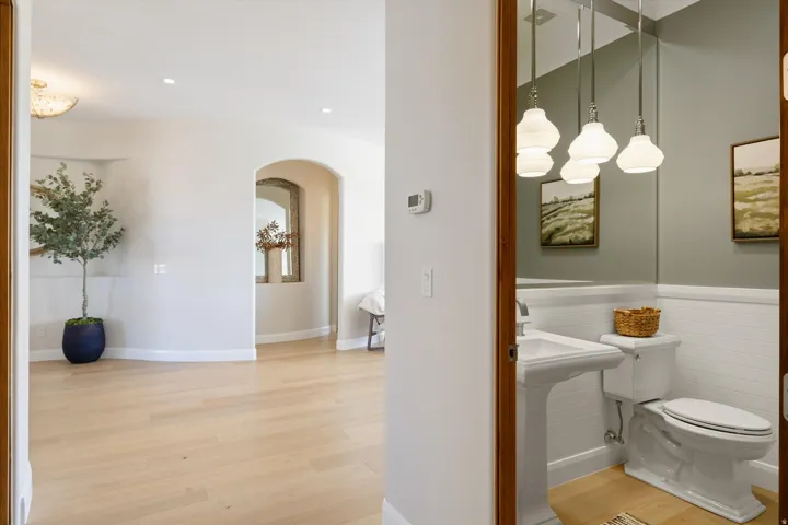 Hardwood-finish flooring, recessed lighting, and an arched doorway