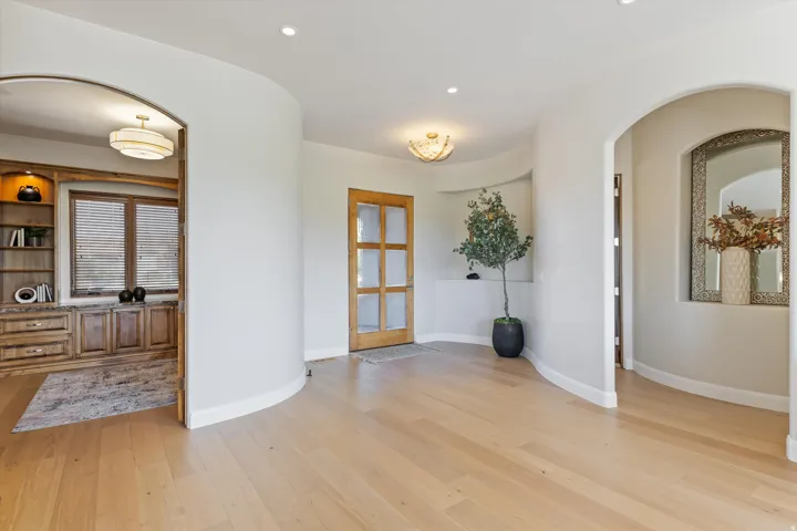 Light wood-finish flooring with curved architectural walls
