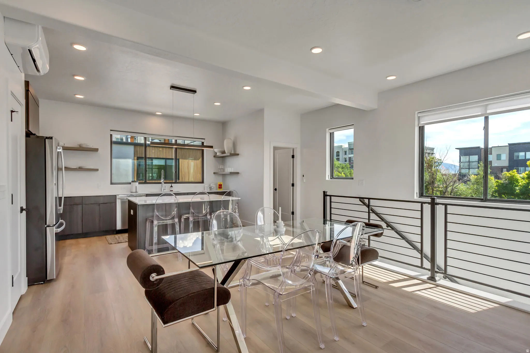Modern kitchen featuring dark wood-finish cabinetry, stainless steel appliances, and a central island with counter seating
