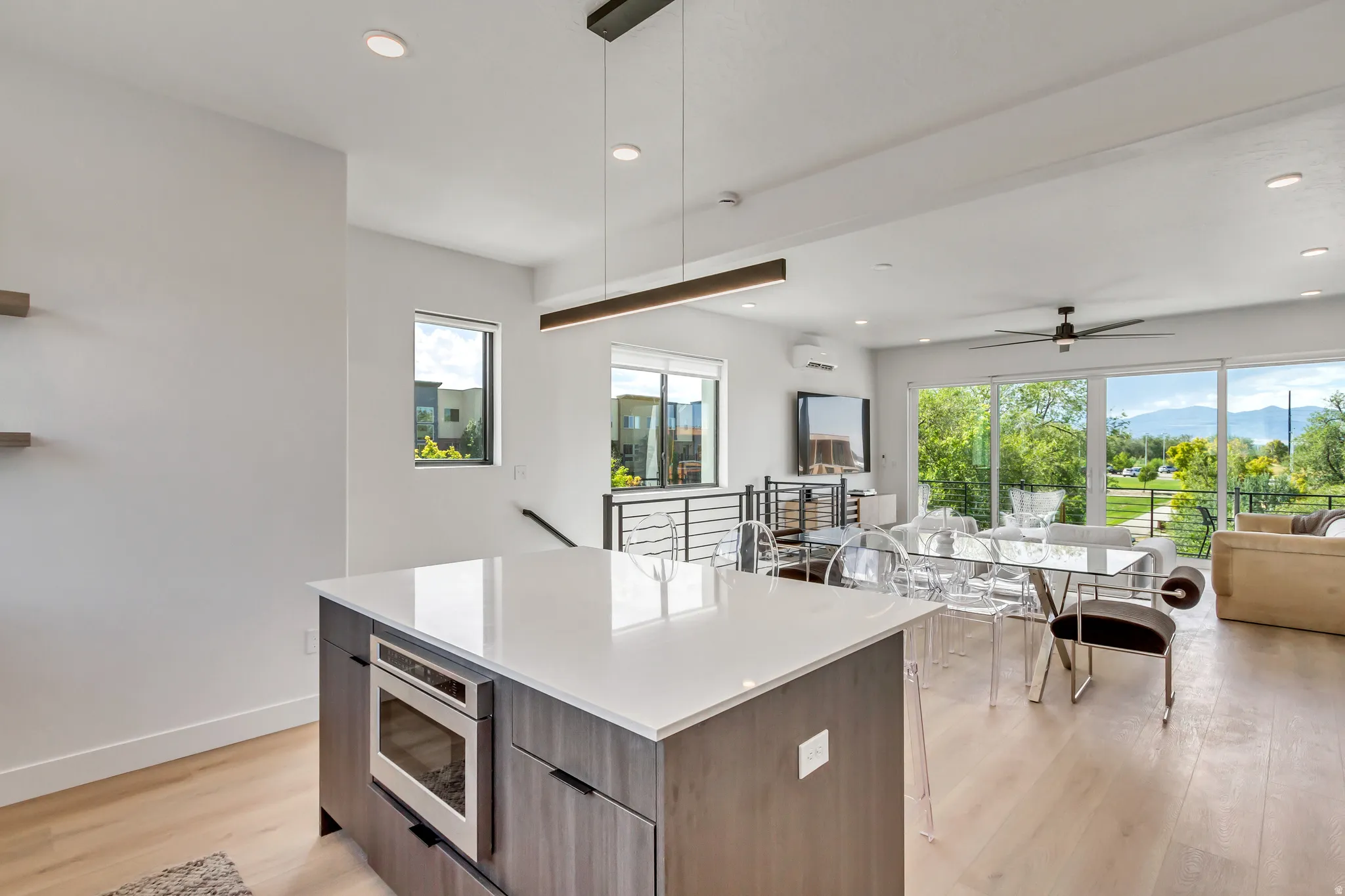 Kitchen island with a light-toned countertop and built-in microwave drawer