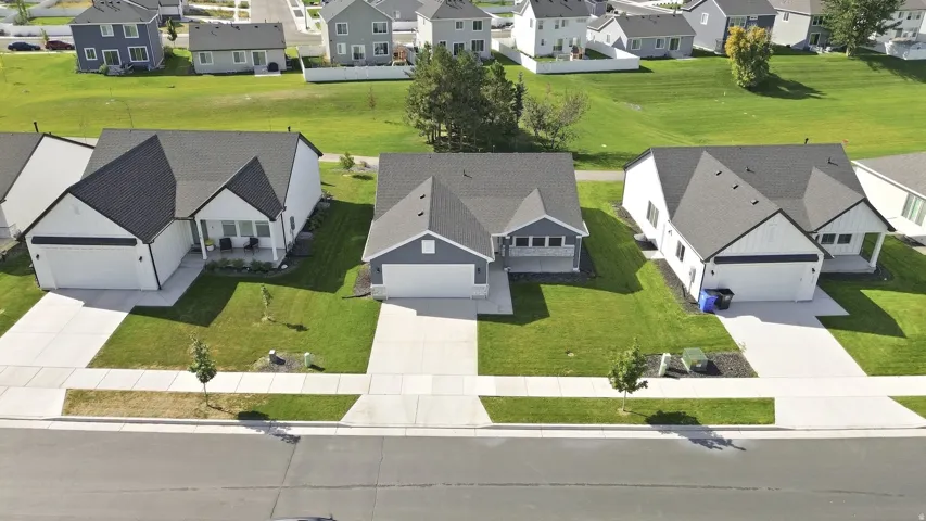 Contemporary exterior with dark shingle roofing, white siding, and an integrated garage