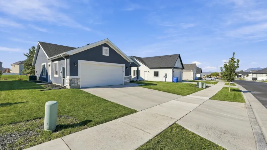 Contemporary exterior with dark siding, white trim, and a two-car garage