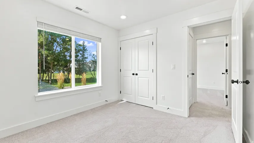 Recessed lighting, light-toned carpeting, white interior doors, and white trim