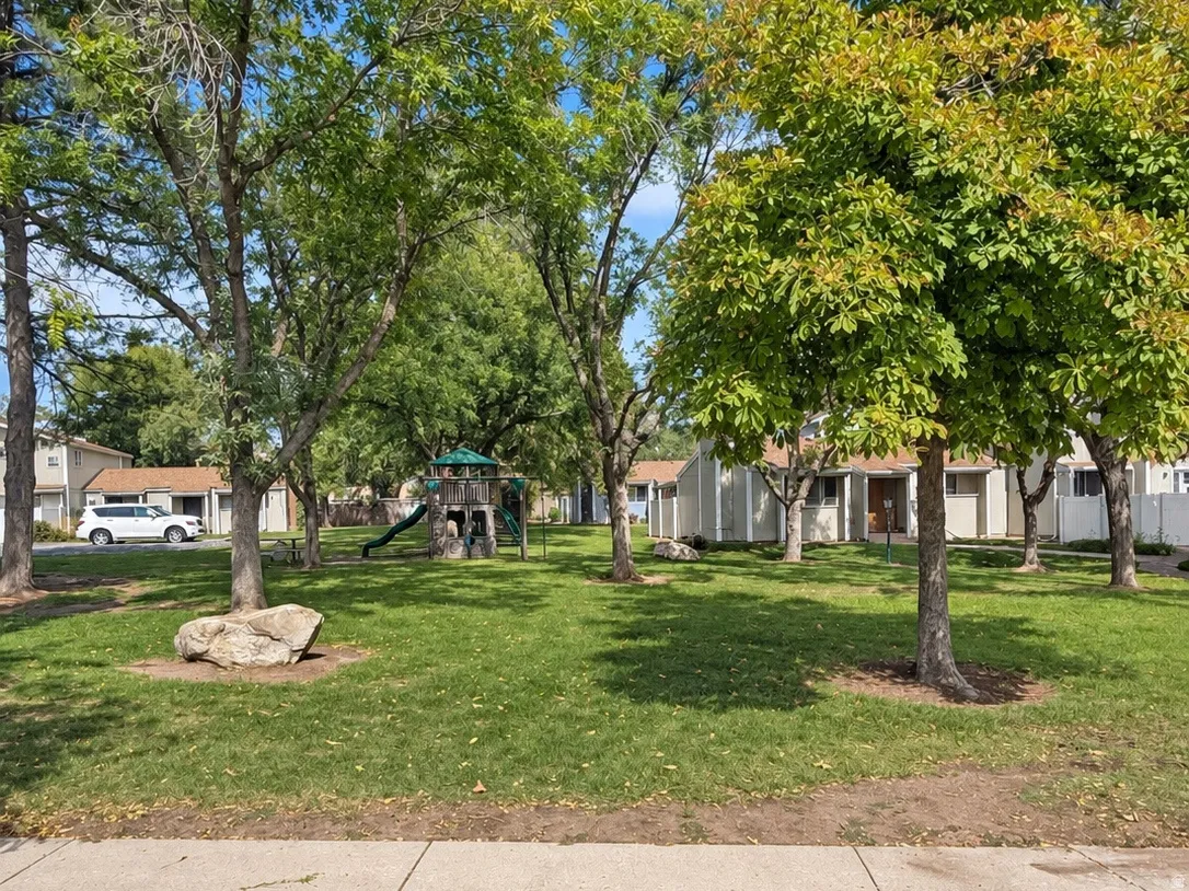 Community green space featuring mature trees and a manicured lawn