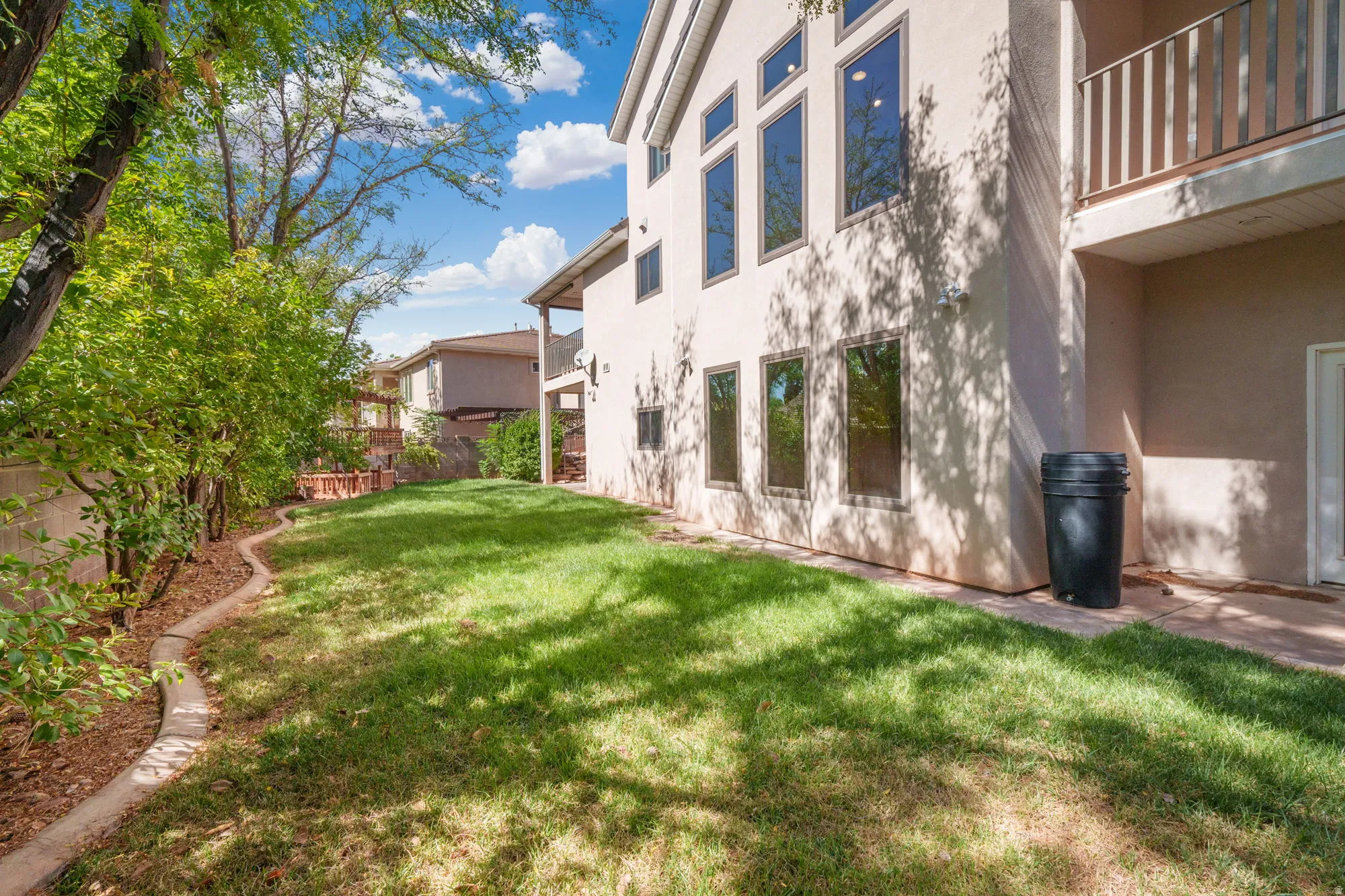 Expansive lawn area with mature perimeter foliage