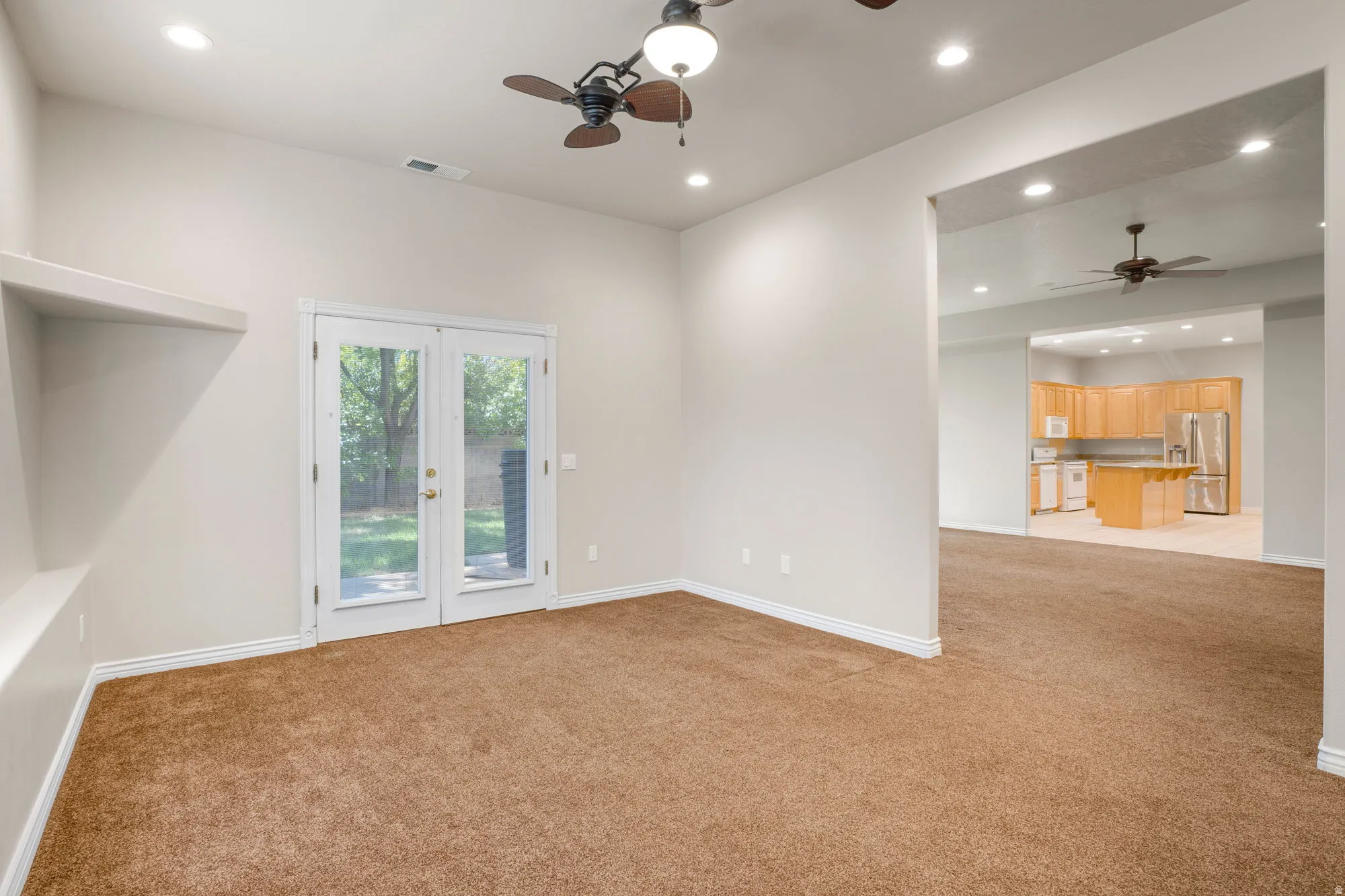 Vaulted ceiling with recessed lighting and ceiling fans