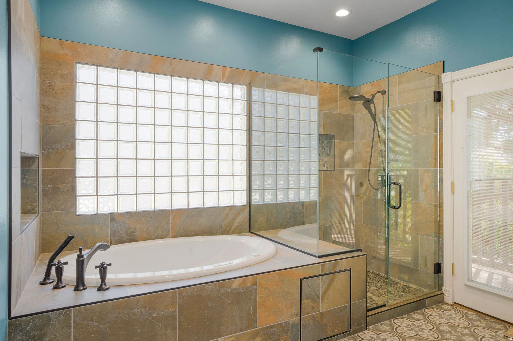Built-in soaking tub with dark-toned fixtures