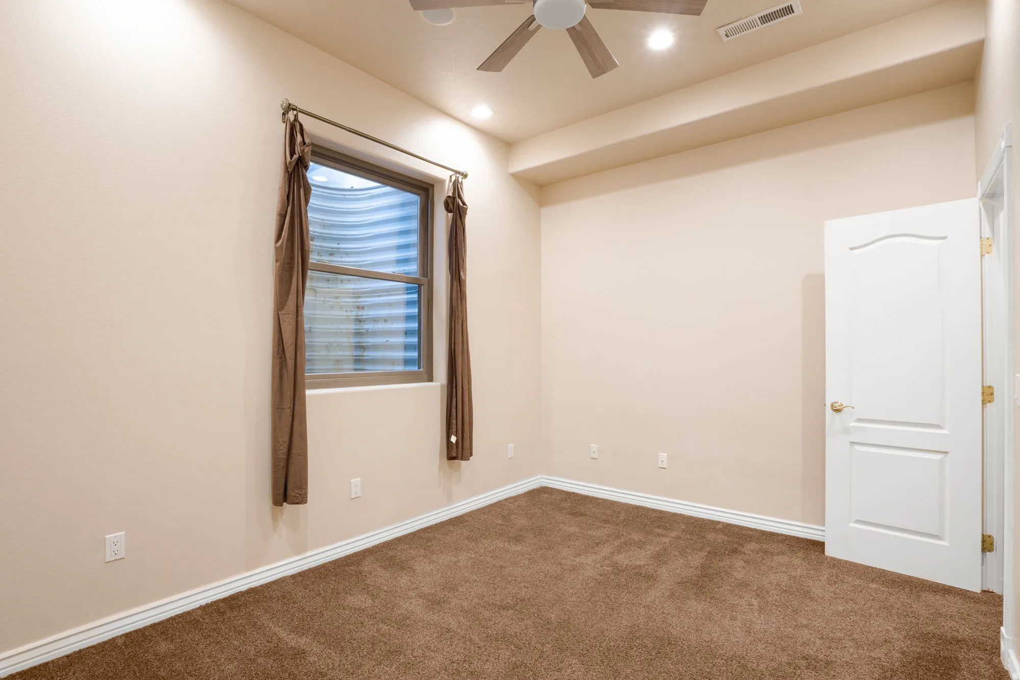 Wall-to-wall carpeting, recessed ceiling lighting, and a ceiling fan with light fixture