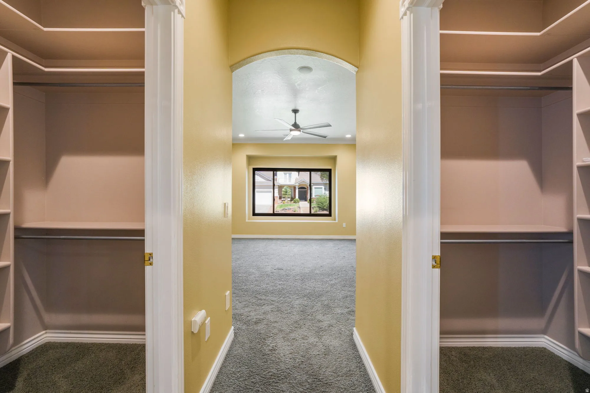 Dual custom closet systems featuring shelving and hanging rods