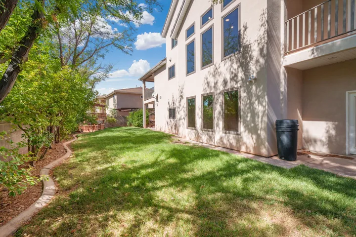 Expansive lawn area with mature perimeter foliage