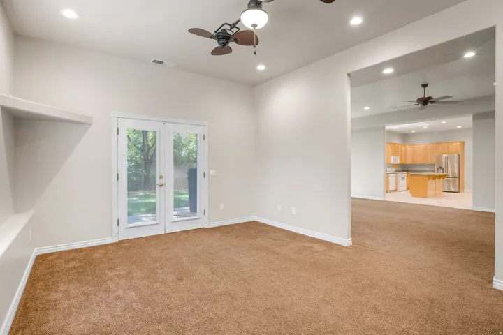 Vaulted ceiling with recessed lighting and ceiling fans