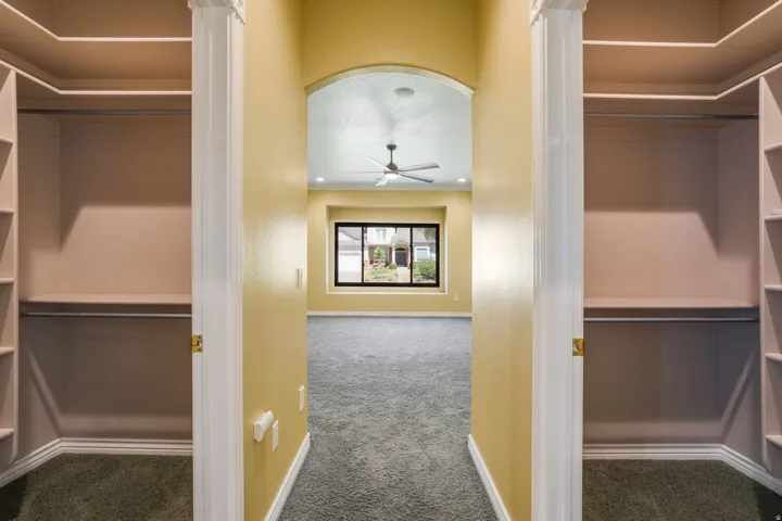 Dual custom closet systems featuring shelving and hanging rods