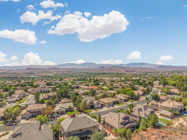 Expansive residential area with diverse home styles, mature landscaping, and mountain backdrop