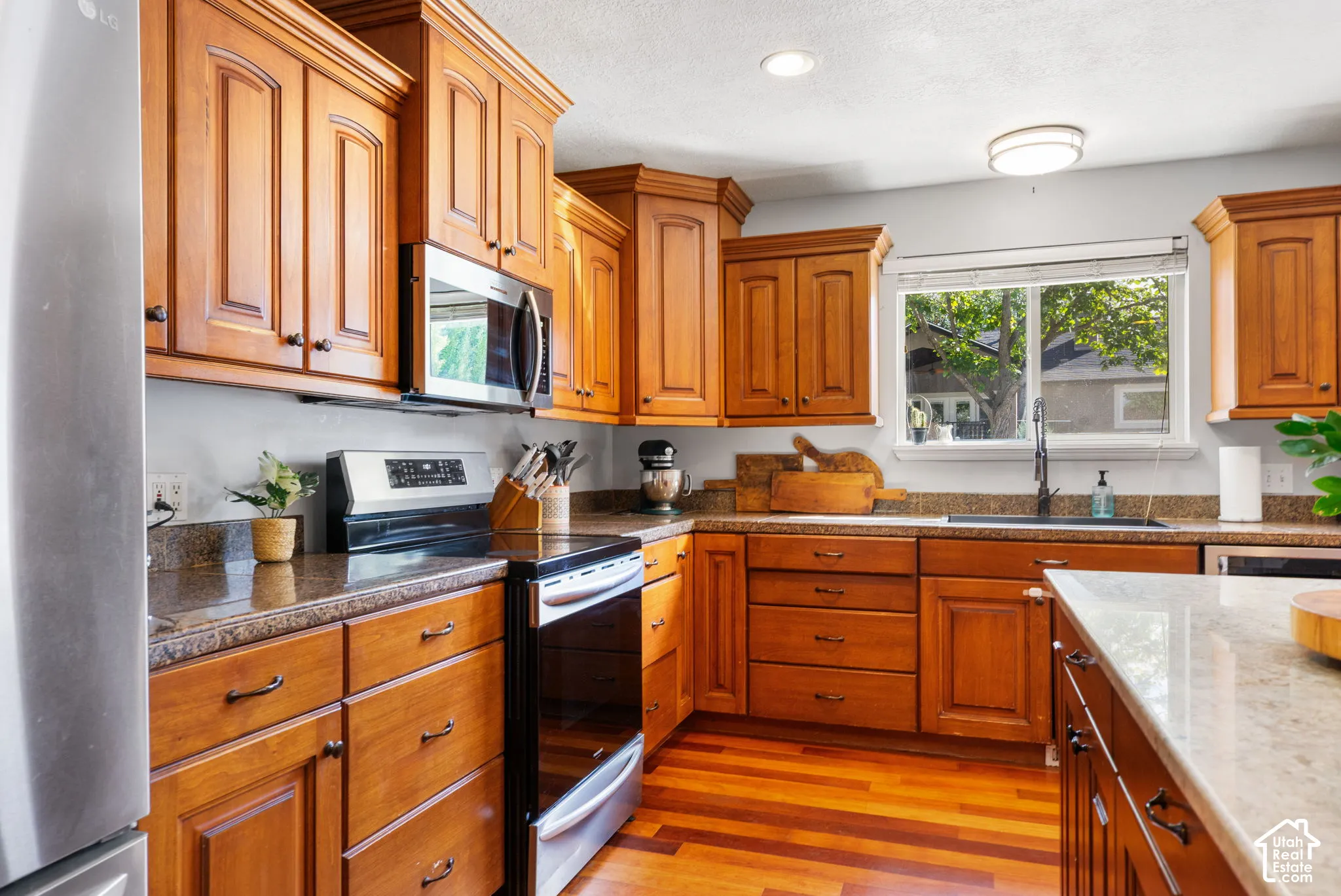 Wood-finish cabinetry paired with stone countertops