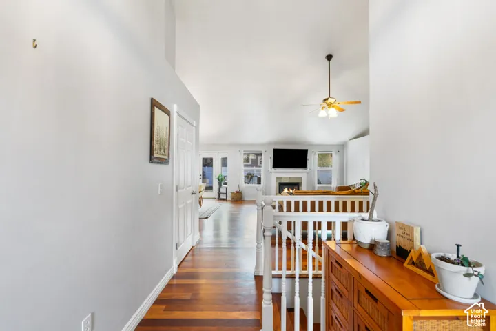 Hardwood-finish flooring throughout, a vaulted ceiling, and white painted walls