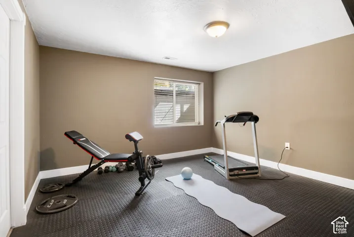 Recessed window, neutral wall paint, white trim, overhead lighting, and durable rubber flooring