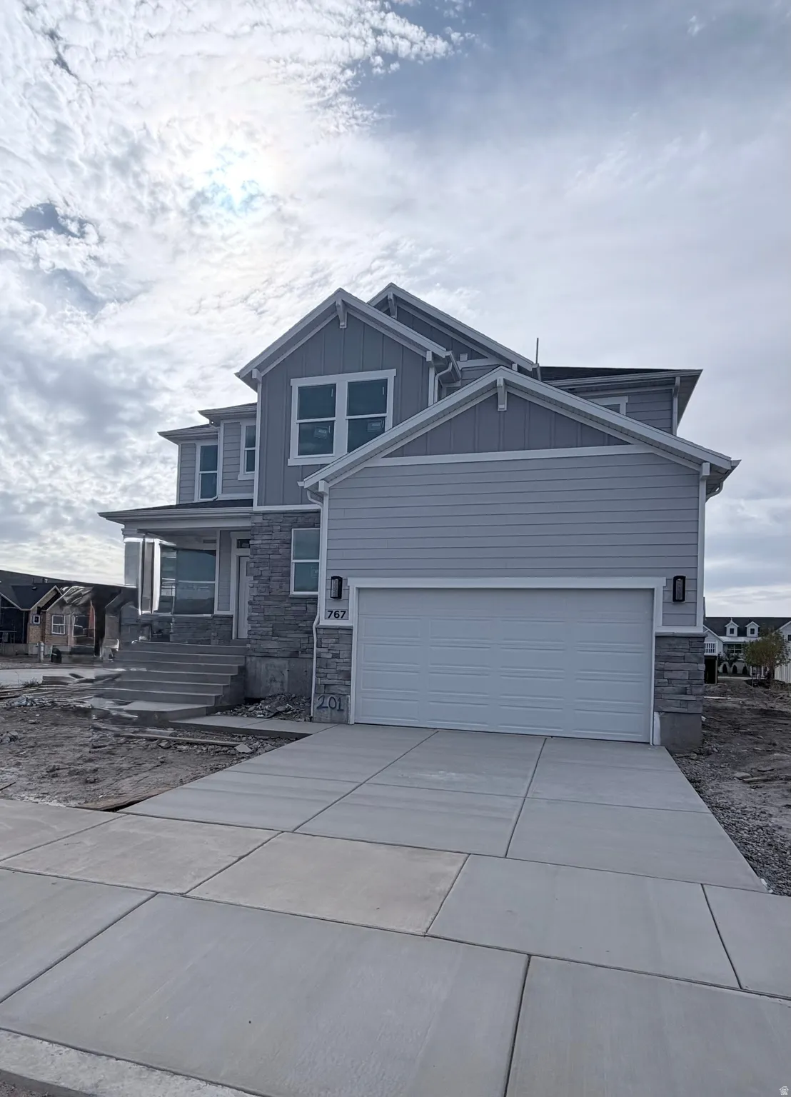 Two-story exterior with horizontal siding and stone veneer accents