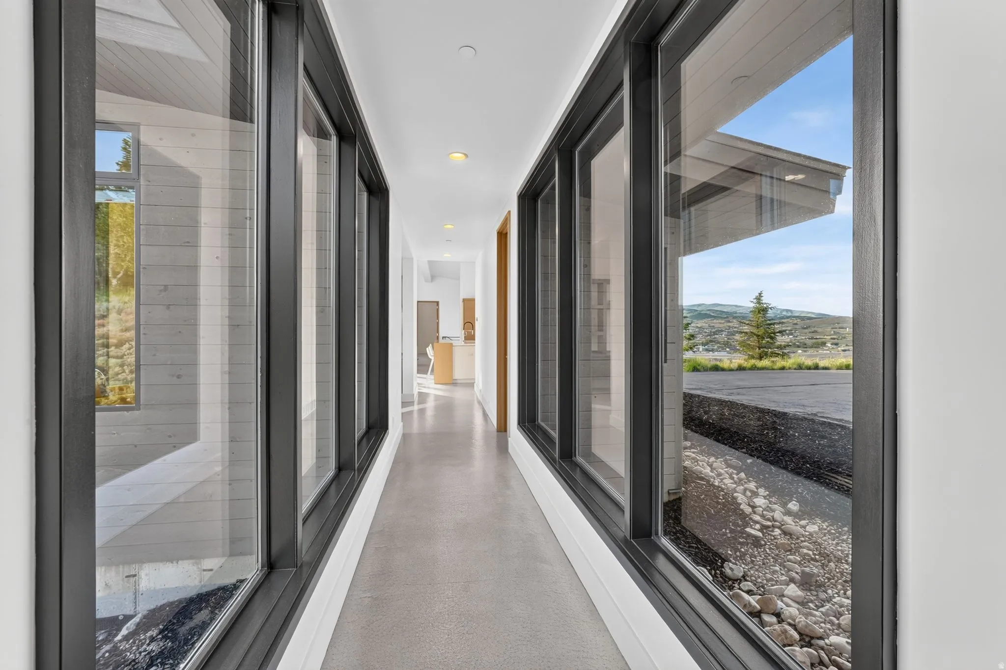 Corridor with polished concrete flooring and recessed lighting