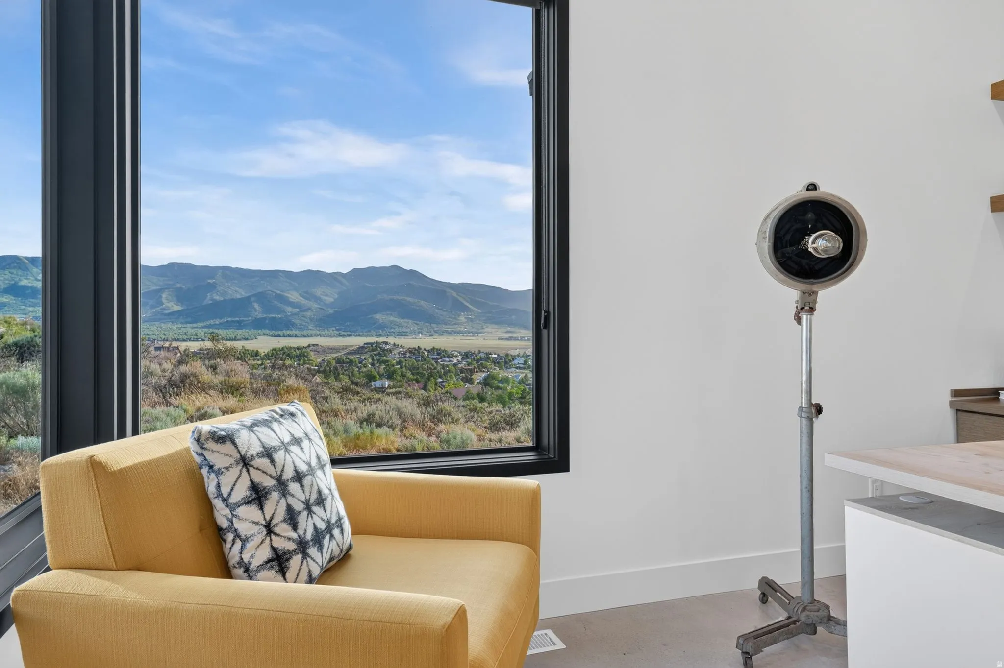 Expansive window framing a mountainous landscape