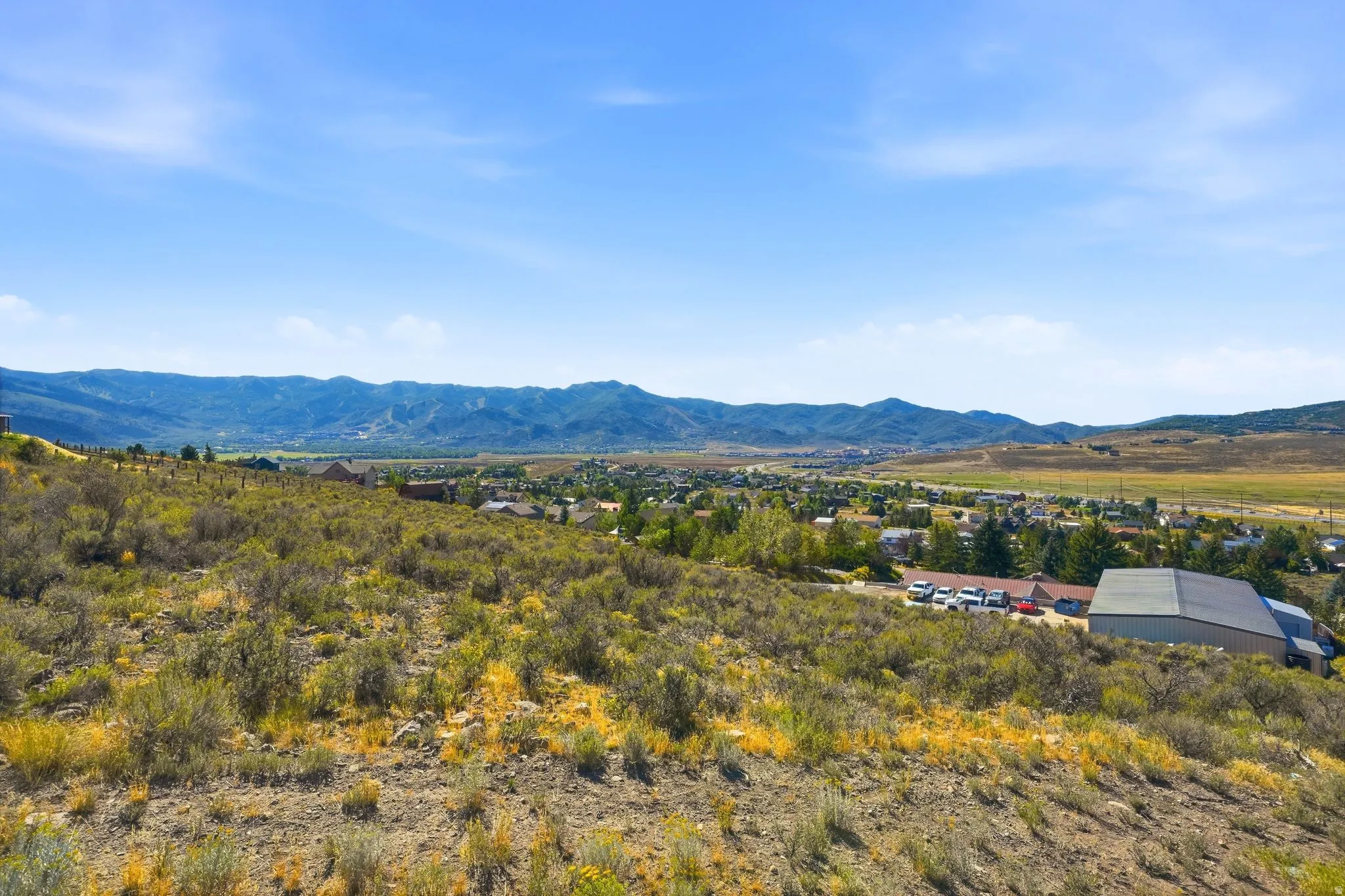 Expansive terrain featuring natural vegetation and distant mountain ranges