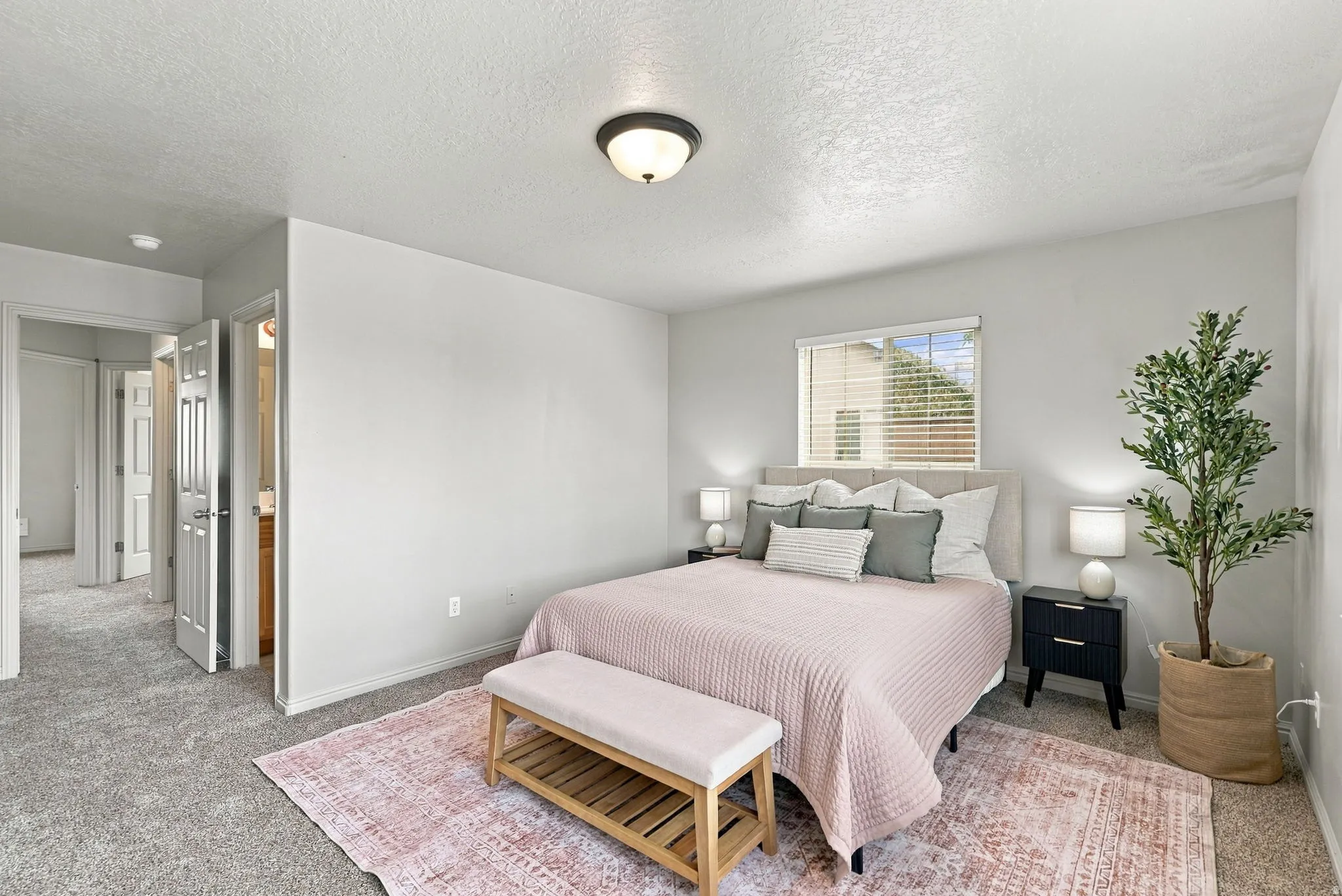 Recessed ceiling light, neutral wall colors, window with blinds, paneled interior doors, and carpet flooring