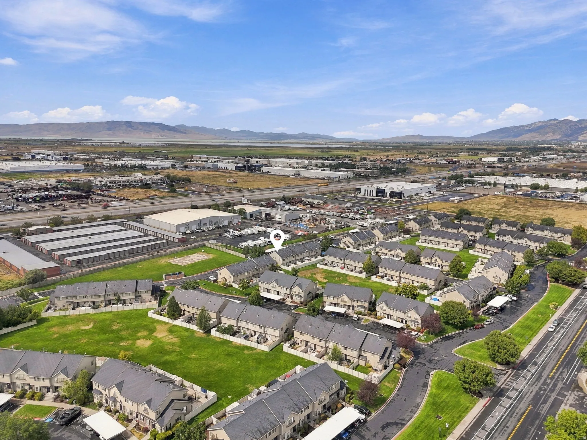 Townhome community with green spaces and mountain backdrop