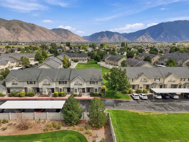 Mountain backdrop, developed neighborhood, townhome properties, covered parking, manicured green spaces