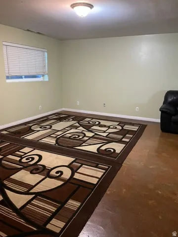 Recessed lighting, light-toned walls, and a window with blinds