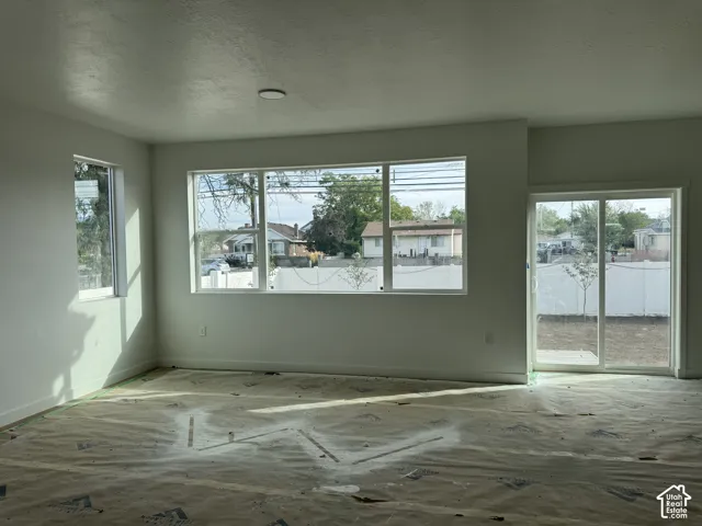 Multiple windows, recessed ceiling lighting, and sliding glass door
