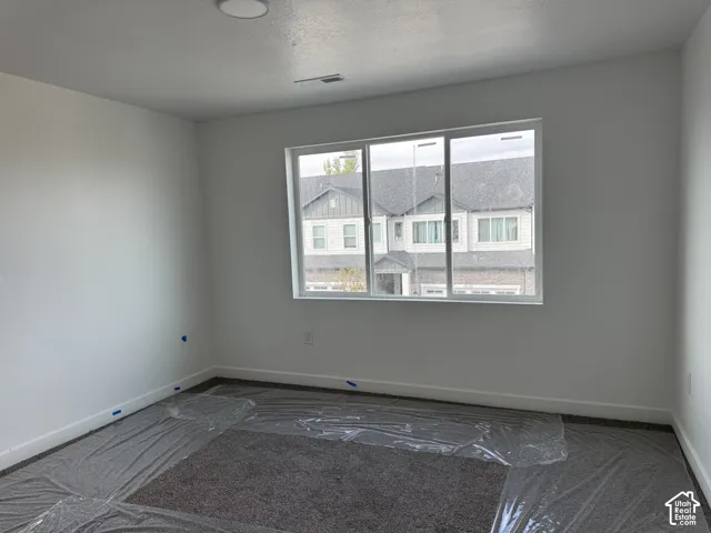 Neutral wall paint, recessed ceiling lighting, three-pane window, and carpeted flooring