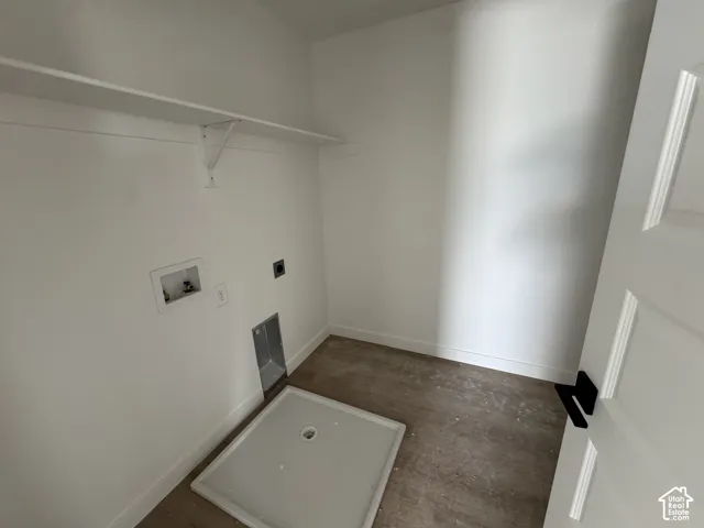 White wall shelving with bracket support, hookups for appliances, and a white paneled door with black hardware