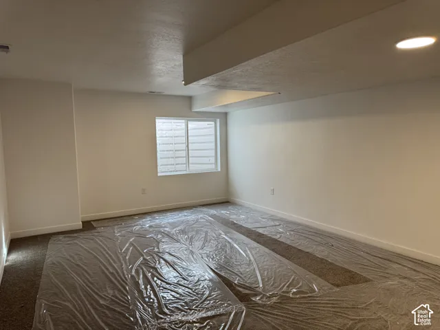 Recessed lighting, white walls, and a window with horizontal blinds