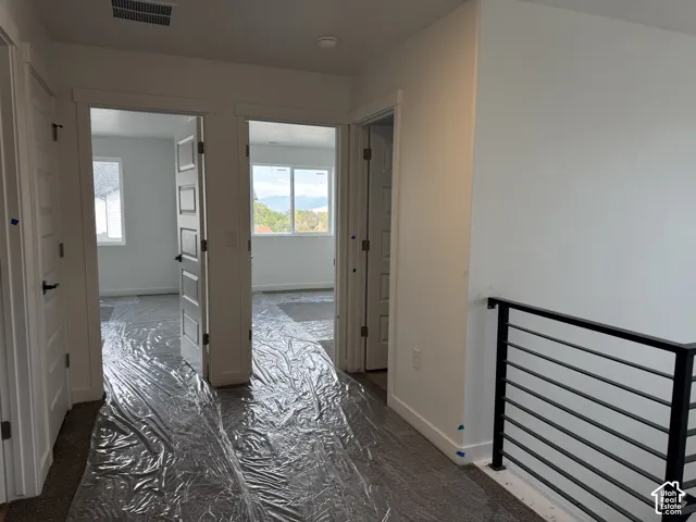 Modern railing with horizontal balusters, white trim, and white paneled doors