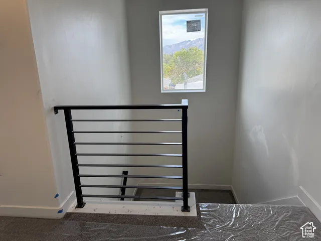 Modern horizontal rod railing with a matte black finish, offering a framed mountain backdrop