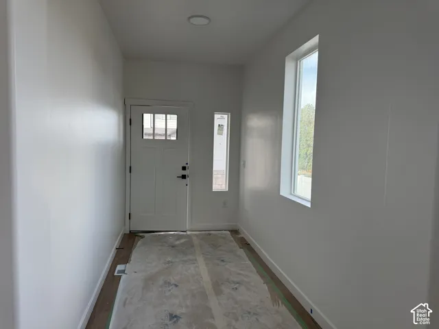 Entryway featuring a panel door with lites, side lite, and overhead recessed lighting
